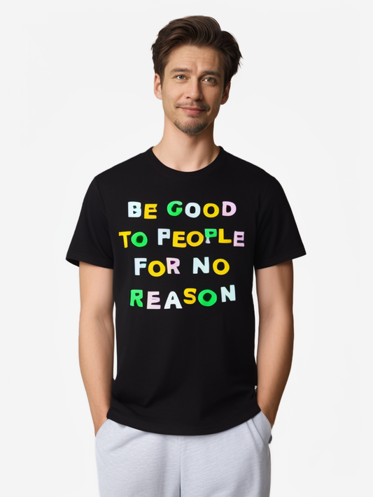 Front view of model wearing black graphic tee with colorful slogan "Be Good to People for No Reason".