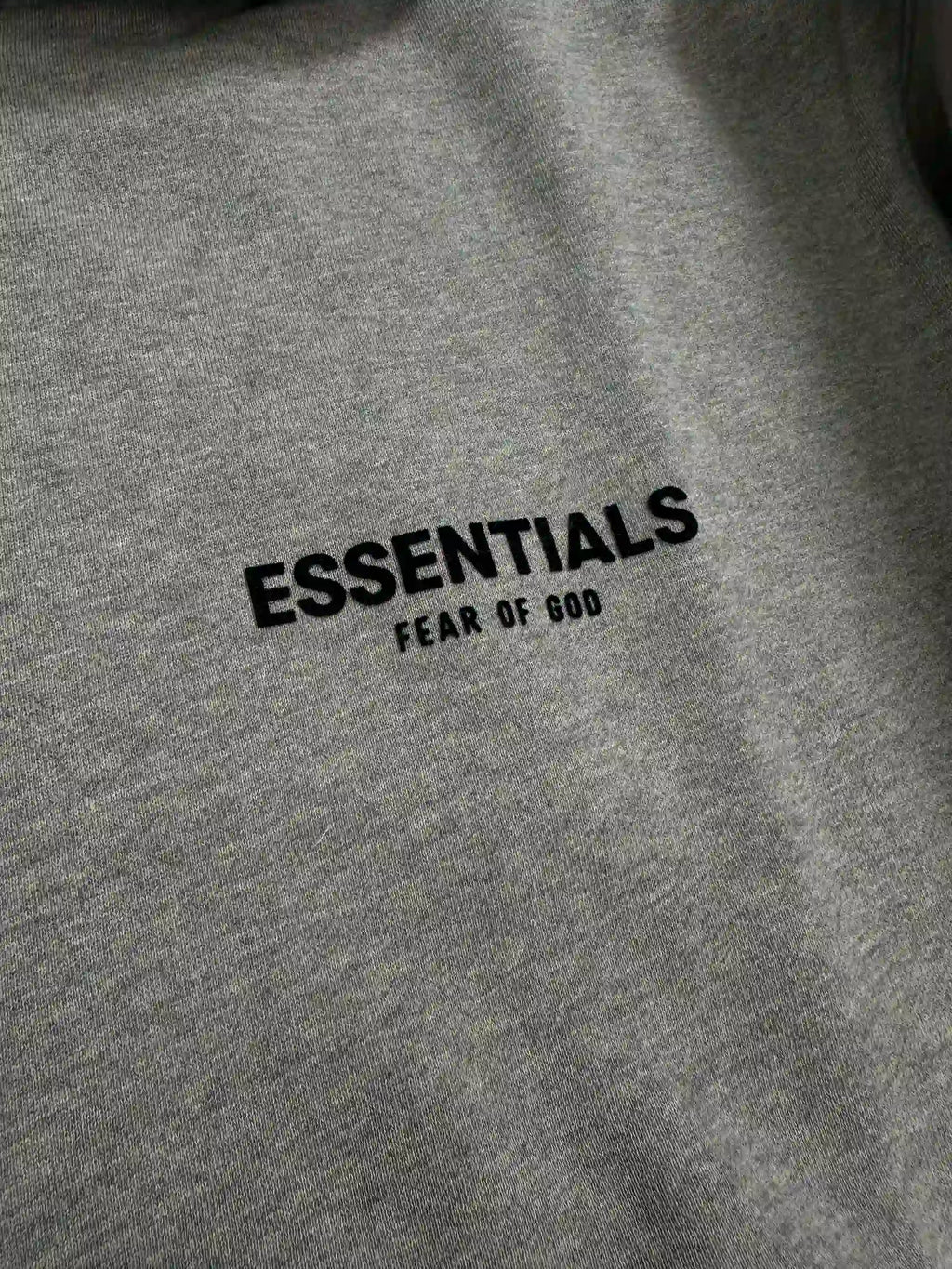 Front chest logo detail of ESSENTIALS fleece hoodie, dark oatmeal color, relaxed oversized fit streetwear sweatshirt