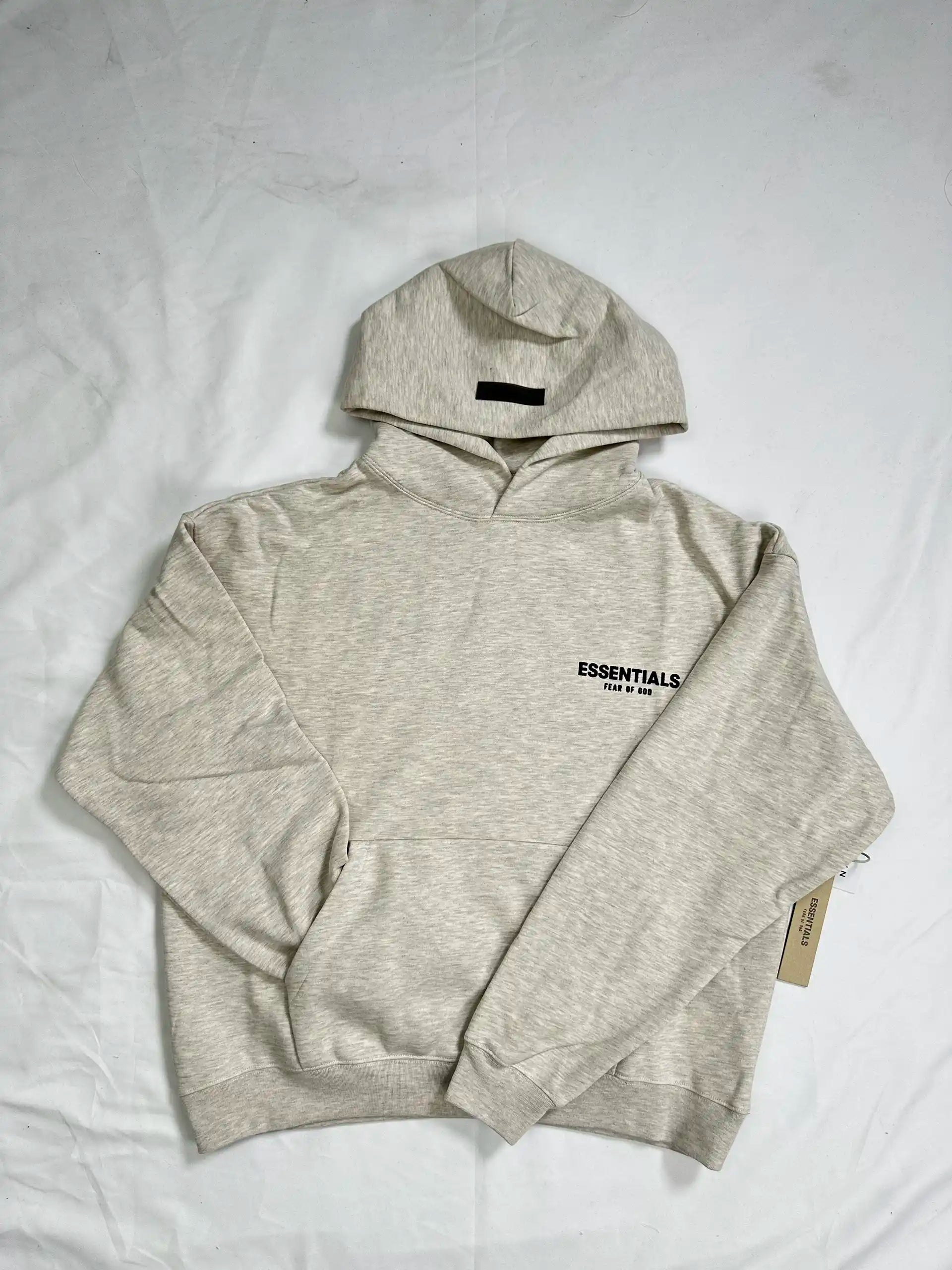 ESSENTIALS 2022 fleece hoodie in Light Oatmeal, front view, relaxed oversized fit, chest logo
