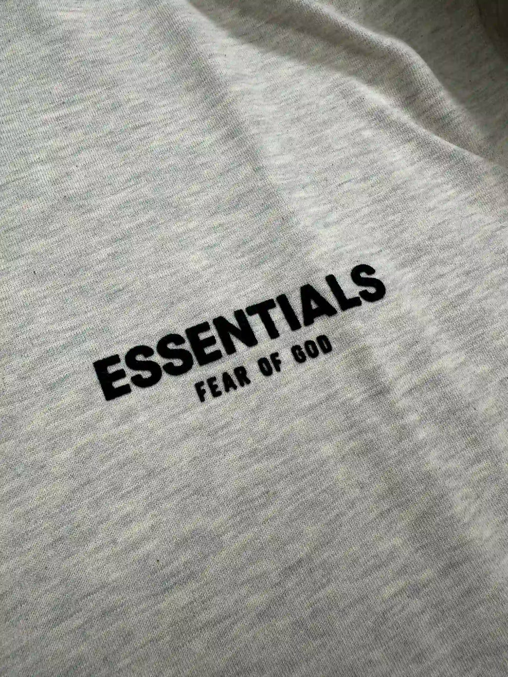 ESSENTIALS 2022 hoodie logo detail on Light Oatmeal fleece fabric