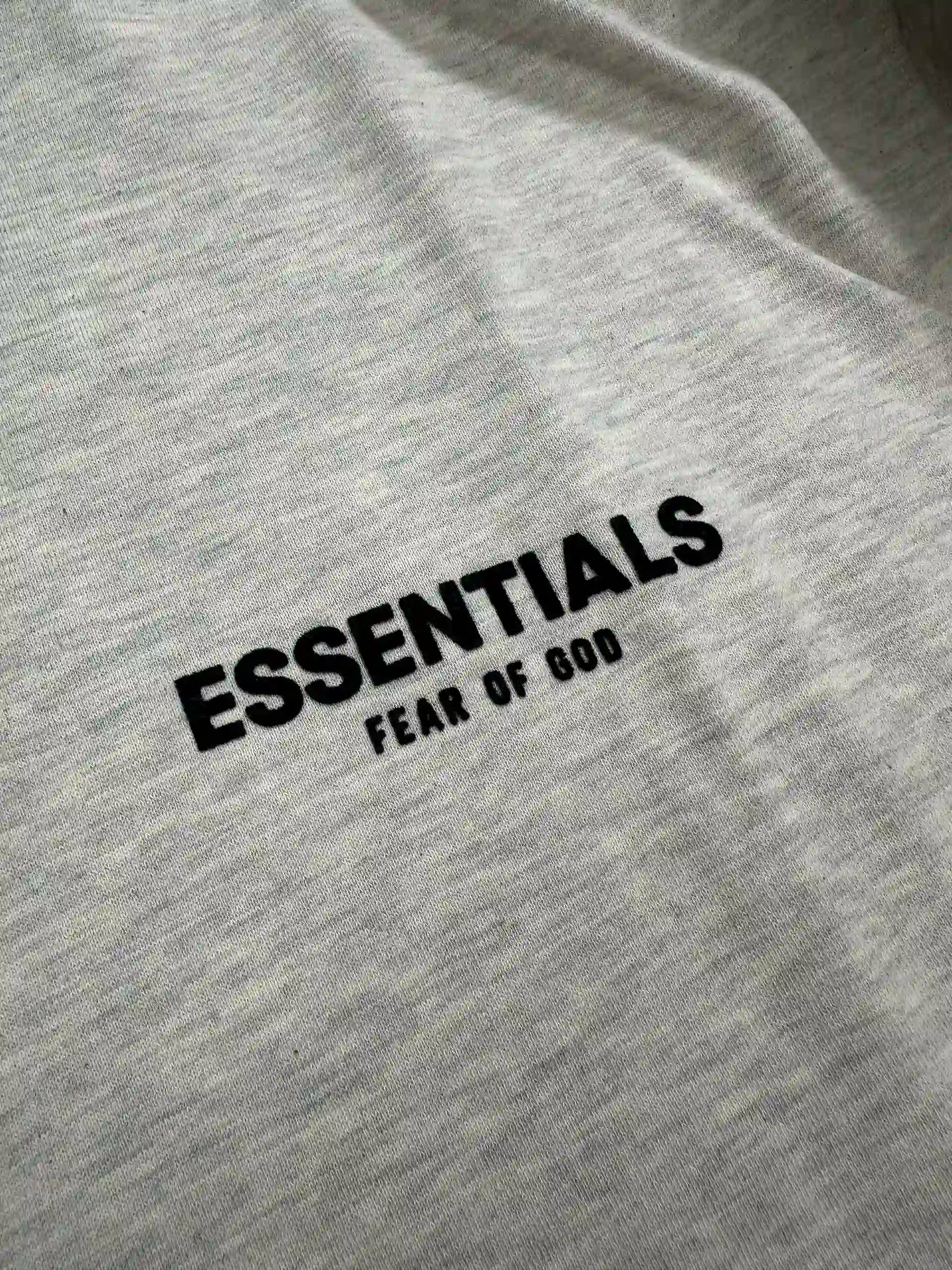 ESSENTIALS 2022 hoodie logo detail on Light Oatmeal fleece fabric