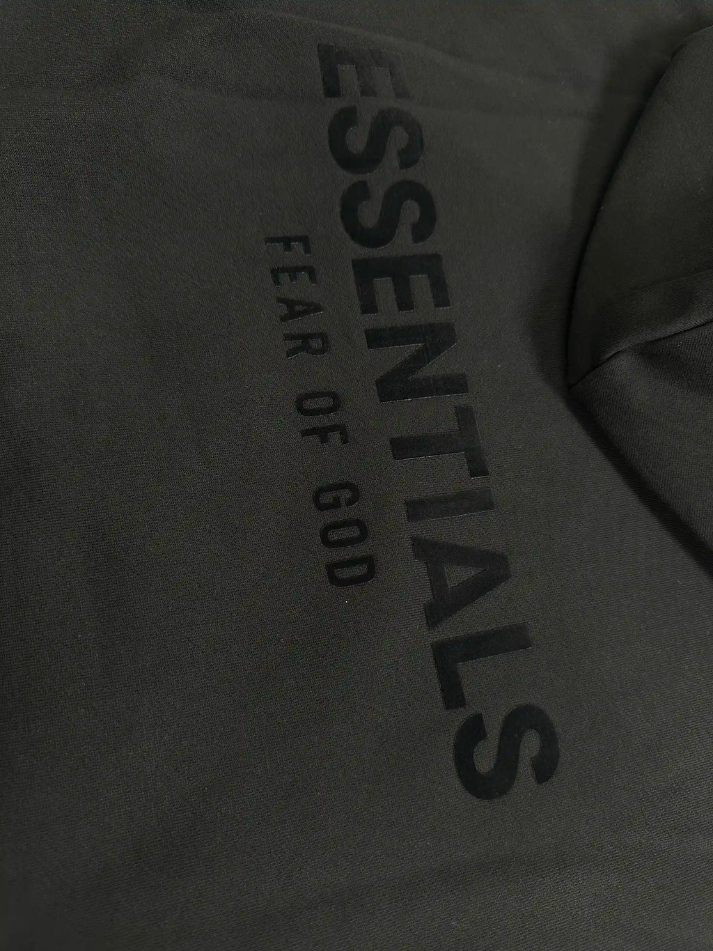 Back view of Fear of God Essentials hoodie with large ESSENTIALS logo