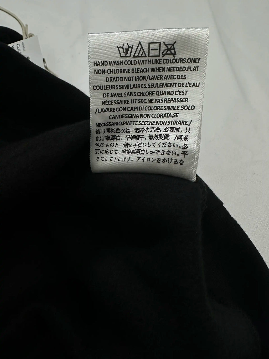 Care instructions label on Fear of God Essentials hoodie