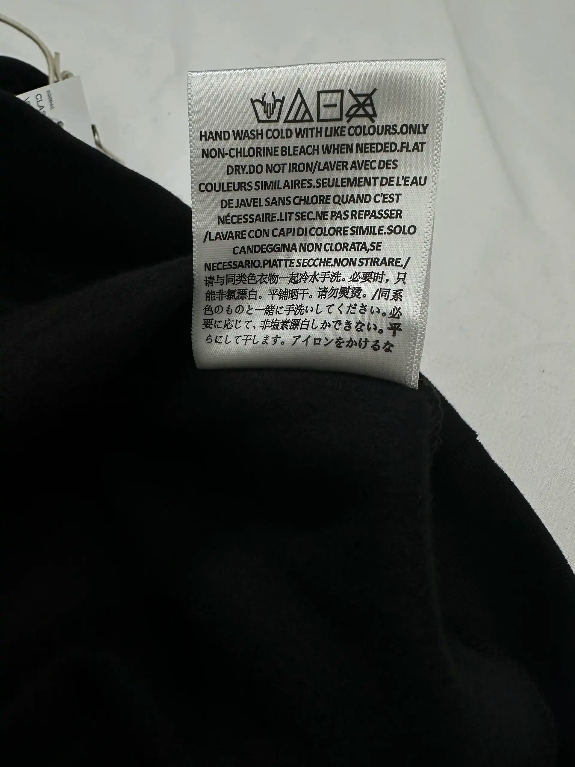 Care instructions label on Fear of God Essentials hoodie