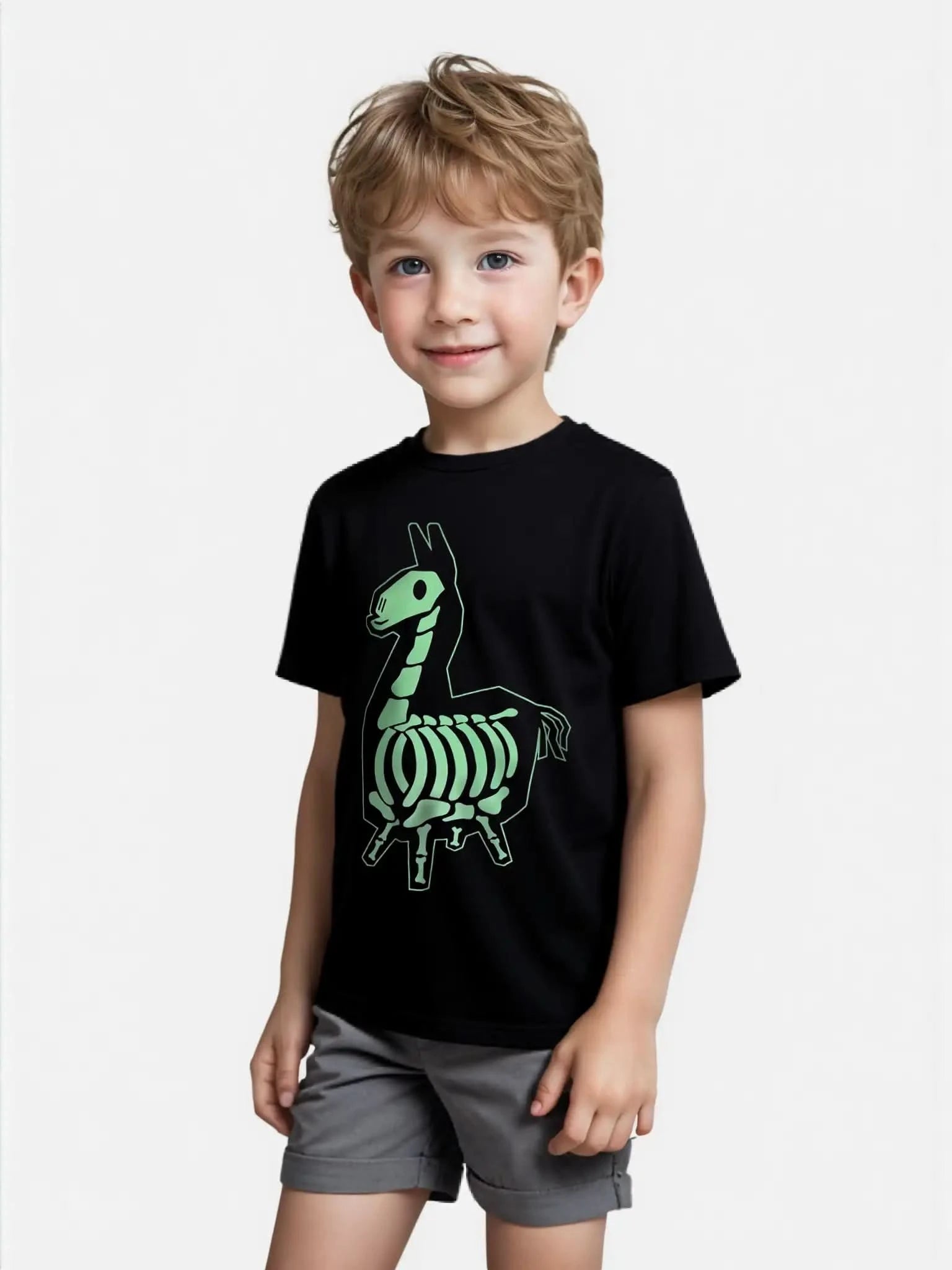 Smiling young boy wearing a black Fortnite T-shirt with green skeleton llama graphic, unisex kids fit, perfect for gamers and casual outfits.