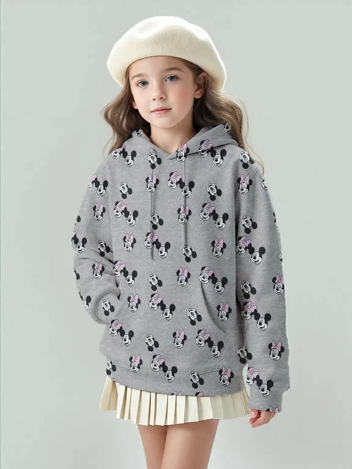 Girl model wearing Disney Mickey & Minnie gray hoodie in big girl size, all-over cartoon print.