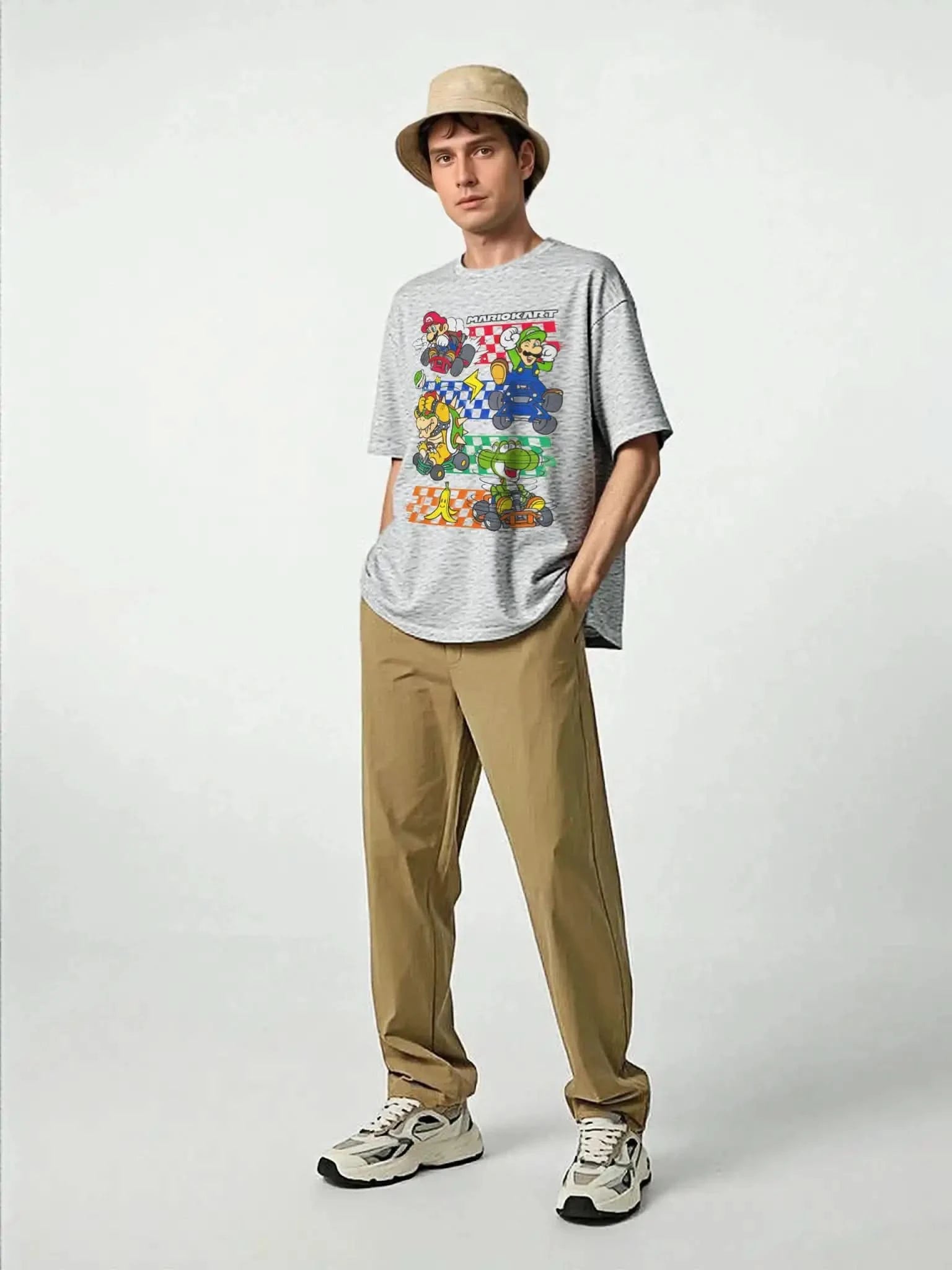 Lifestyle image of adult male model wearing Mario Kart™ licensed graphic t-shirt in heather gray, styled with khaki pants and sneakers.