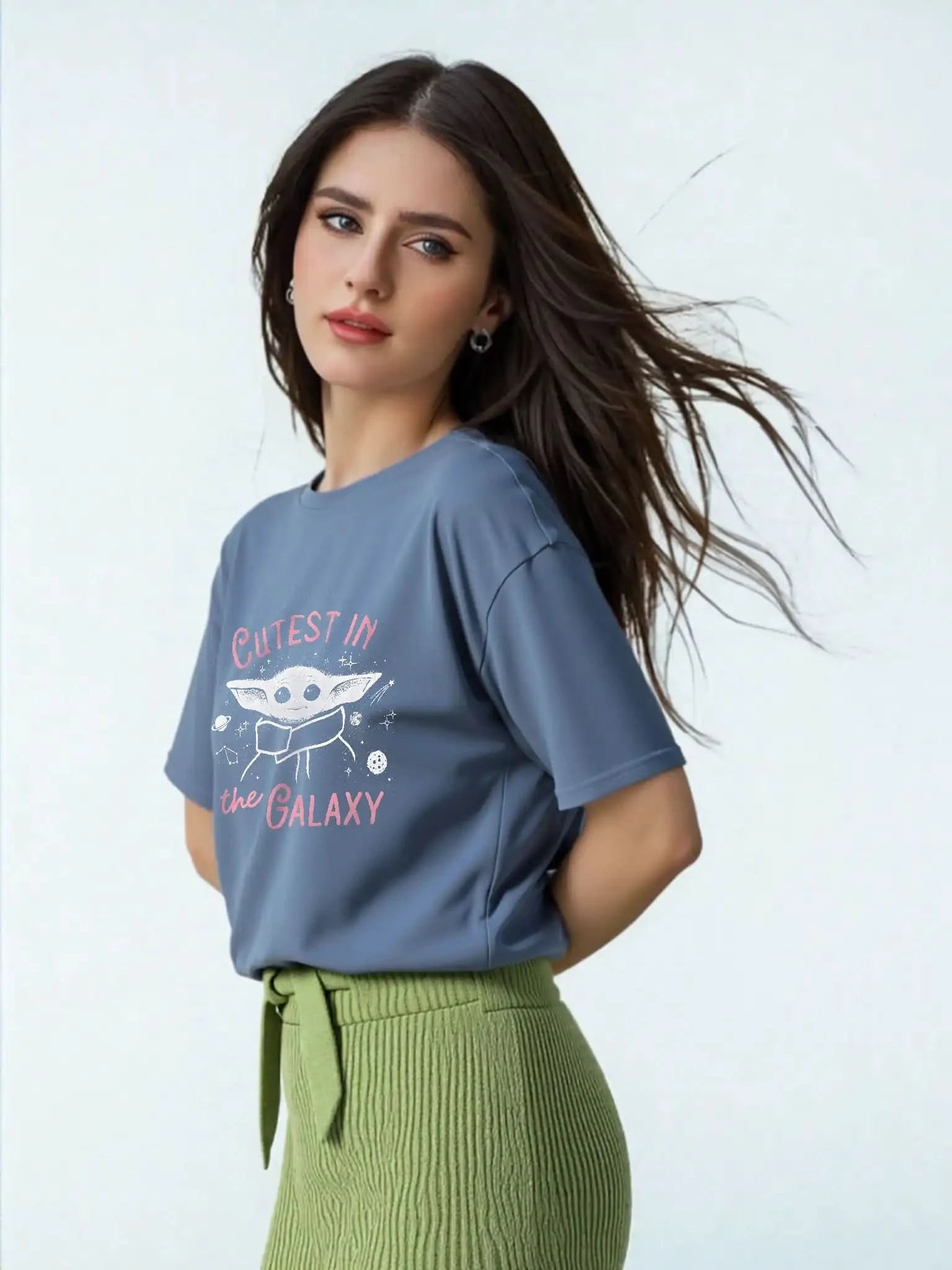 Side view of model wearing Star Wars™ Grogu slogan tee with “Cutest in the Galaxy” text, unisex fit, navy blue.