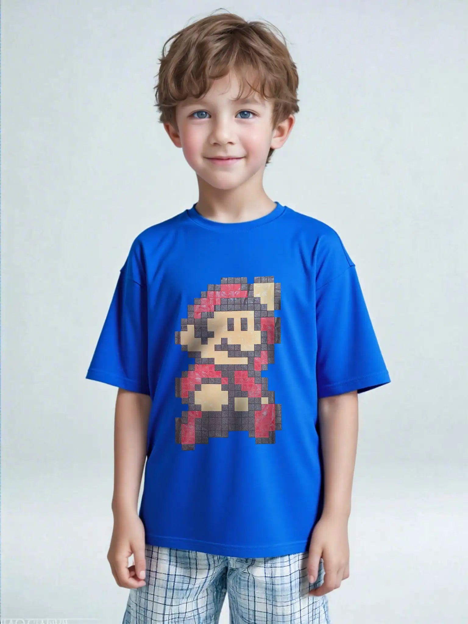 Young boy standing in Super Mario Bros. 3 pixel art graphic tee – retro blue T-shirt for kids.