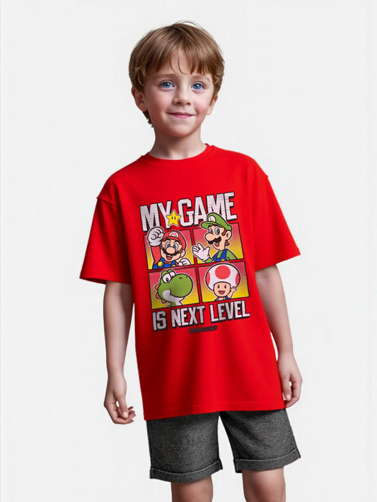 Boy wearing red Super Mario graphic tee with “My Game Is Next Level” slogan and Mario, Luigi, Yoshi, and Toad character panels.
