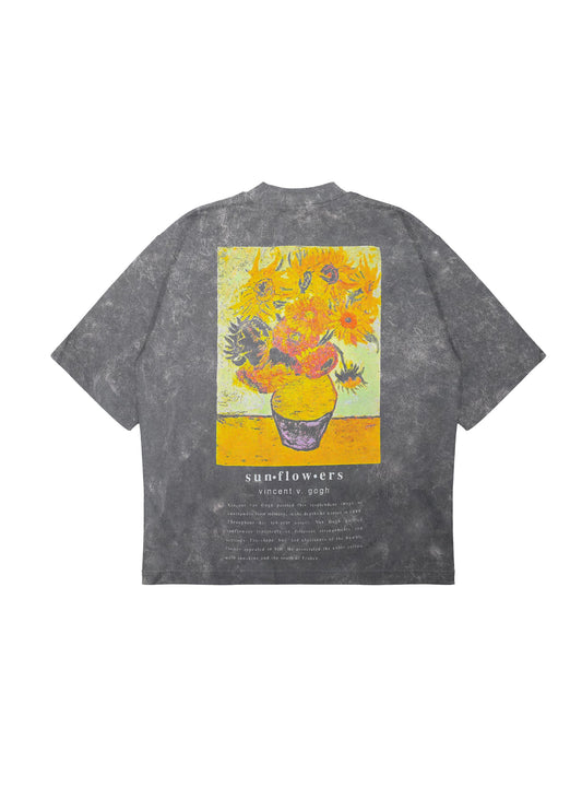 Flat lay of black tee with large Van Gogh Sunflowers painting on the back