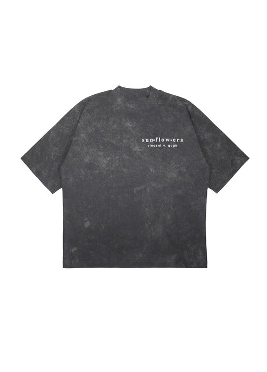 Flat lay front view of black tee with small Sunflowers text print